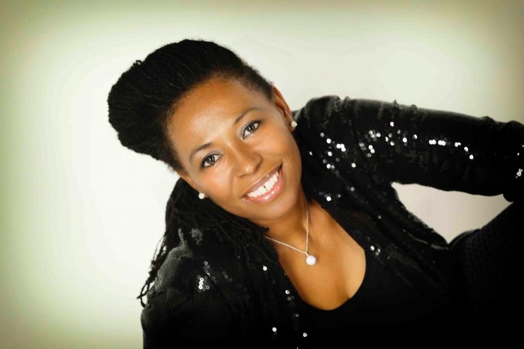 Carroll Thompson poses in a black sparkly jacket.