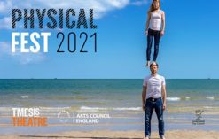 Two performers from physical festival Liverpool standing on each other