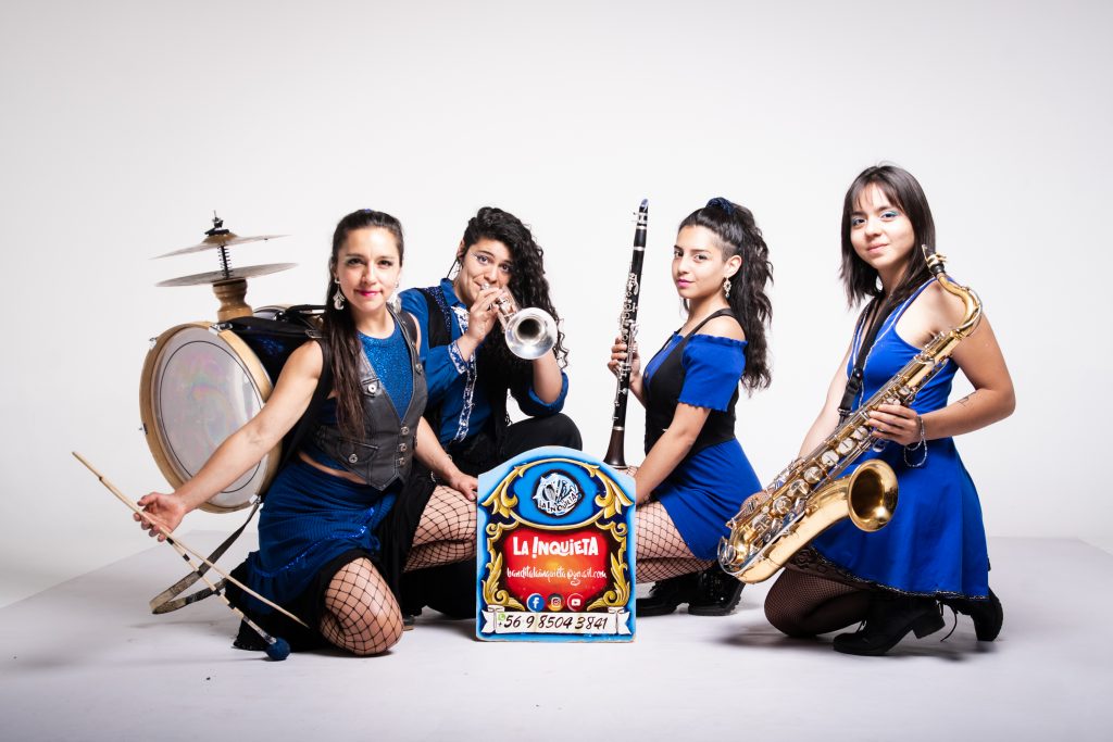 A four piece band posing with their instruments.