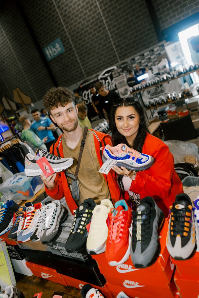 Liverpool’s celebration of sneaker culture celebrates 10-year anniversary Two people holding sneakers at a sneaker convention.